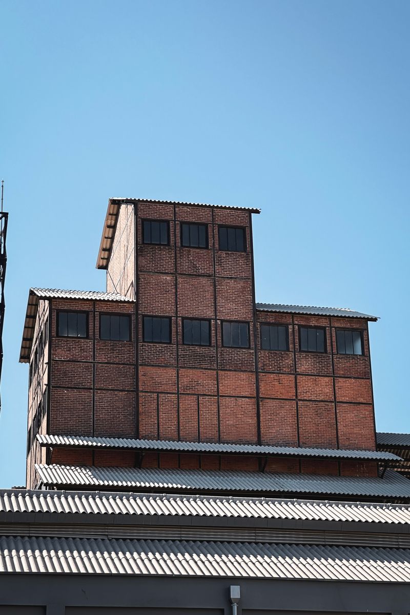 A striking industrial red brick building in Kadıköy, İstanbul with clear blue sky backdrop.